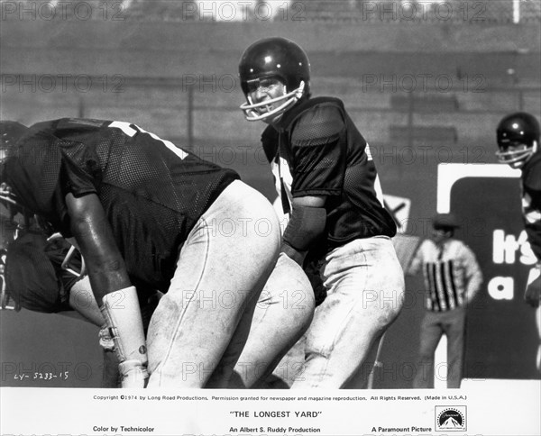 Actor Burt Reynolds, (center), on-set of the Film, "The Longest Yard", Paramount Pictures, 1974