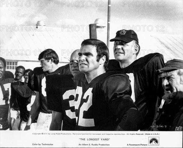 Actor Burt Reynolds, (center), on-set of the Film, "The Longest Yard", Paramount Pictures, 1974
