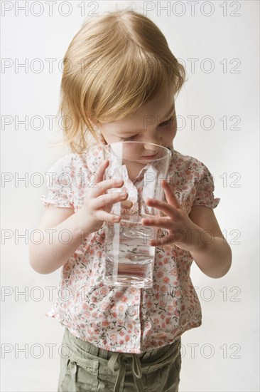 Blonde Toddler Looking into Glass of Water