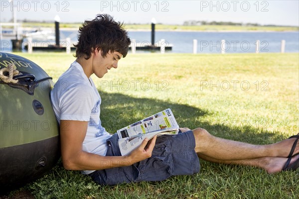 Smiling Young Man Reading