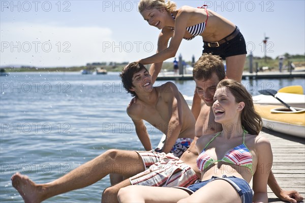 Two Young Couples Having Fun on Edge of Pier