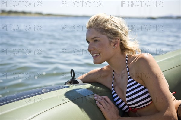 Smiling Young Woman Relaxing in Dinghy