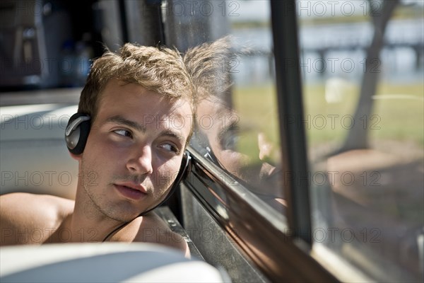 Young Man on Bus Wearing Headphones