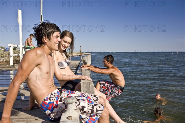 Group of Young Adults on Edge of Pier