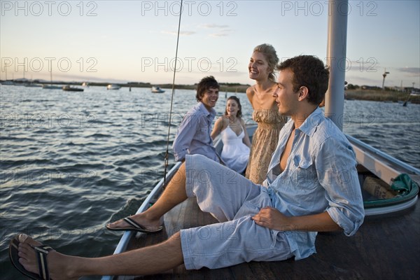 Two Young Couples Relaxing on Sailboat