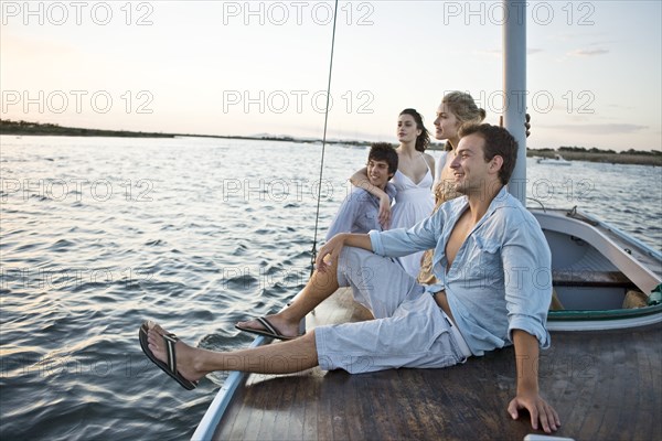 Two Young Couples Relaxing on Sailboat