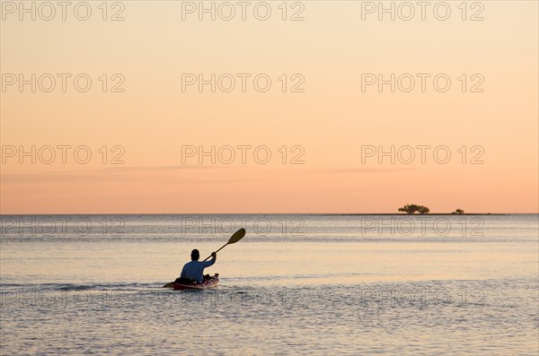 Man Kayaking at Sunset, Florida Keys, USA