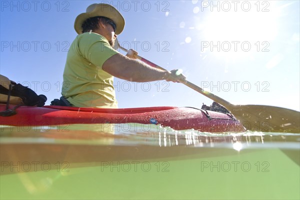 Over and Underwater View of Man Kayaking, Florida Keys, USA