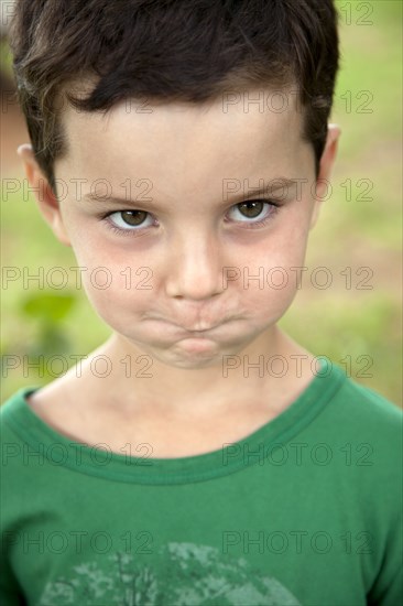 Young Boy Making Funny Face With Cheeks and Mouth