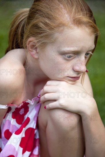 Young Girl Resting Chin on Knee, Portrait