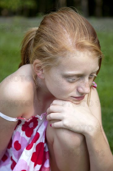 Young Girl Resting Chin on Knee Thinking