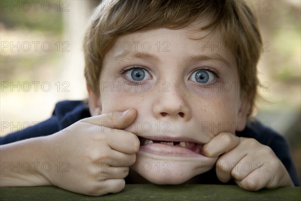 Young Boy Making Funny Face, Close-Up