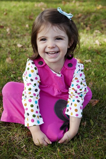 Young Girl in Pink Dress Laughing