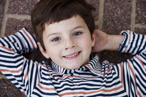 Smiling Boy on Ground Portrait