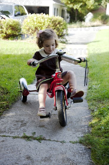 Young Girl Riding Tricycle