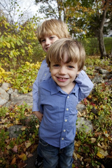 Smiling Boy Standing Behind Another Boy