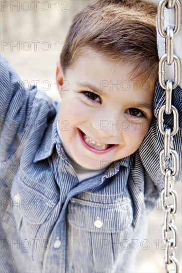 Smiling Boy on Tire Swing, Close Up