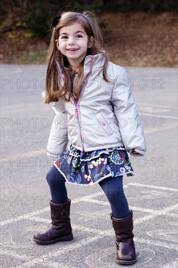 Girl Standing on Hopscotch Court