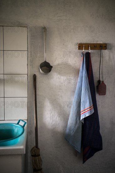 Light Blue dishcloth Hanging next to Old Kitchen Sink