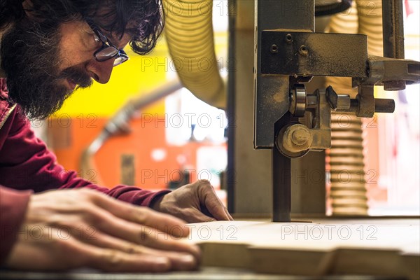 Woodworker Cutting Wood with Band saw