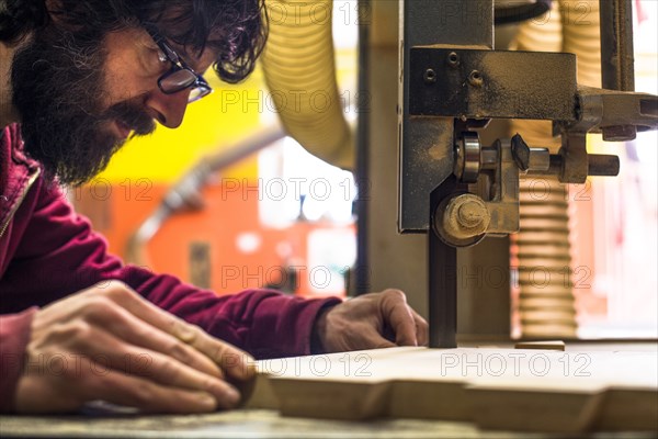 Woodworker Cutting Wood with Band saw