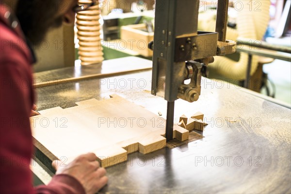 Woodworker Cutting Wood with Band saw