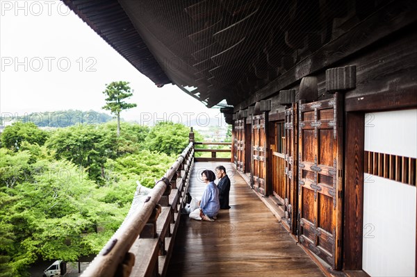 Older Couple Sitting on Balcony of Sanmon Tower at Nanzen-Ji Temple, Kyoto, Japan