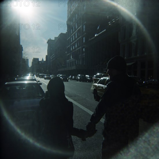 Couple Holding Hands on Sunny City Street