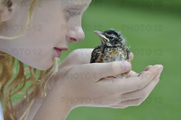 Girl Holding Baby Bird, Close Up