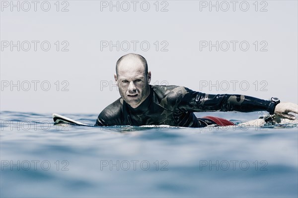 Surfer Preparing to Catch a Wave