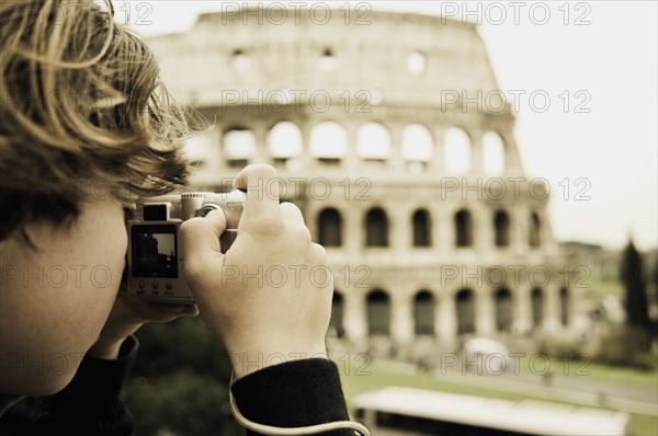 Young Boy Taking Photo of Colosseum, Rome, Italy