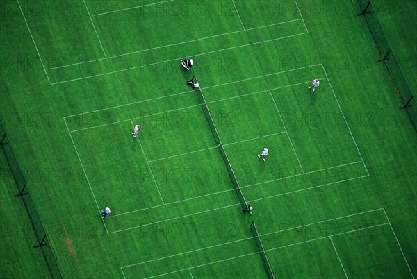 Doubles Tennis Match on Green Court, High Angle View