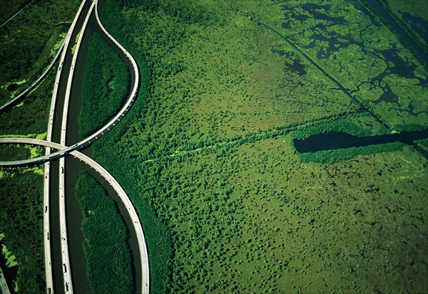 Intersecting Highways near Green Wetlands, High Angle View