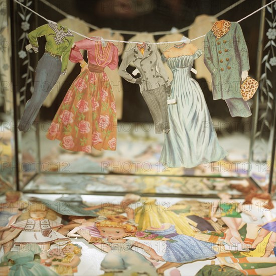 Paper Doll Clothes on Line in Front of Mirror