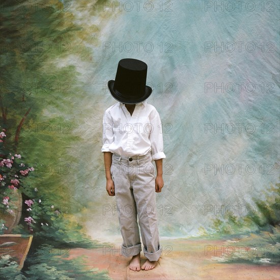 Young Boy with Large Top Hat Covering Face