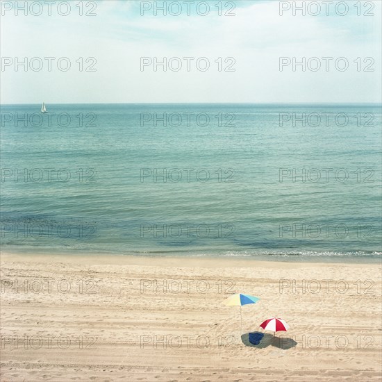 Two Umbrellas on Sandy Beach with Ocean in Background, High Angle View, Los Angeles, California, USA