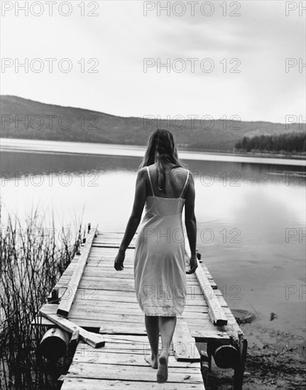 Woman Walking on Dock