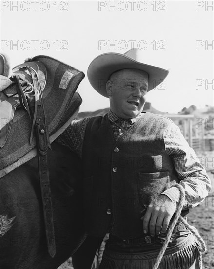 Cowboy Leaning on Horse