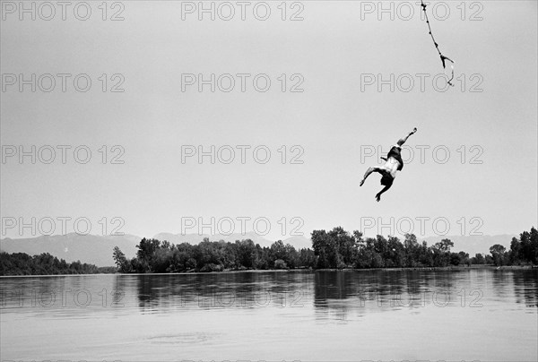 Man Falling from Swinging Rope into Lake