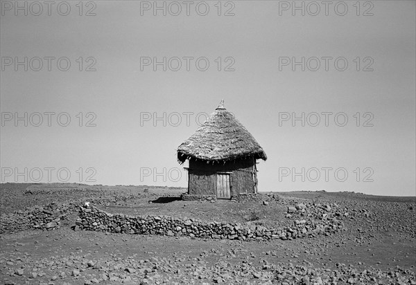 Adobe and Straw House in Field of Rocks