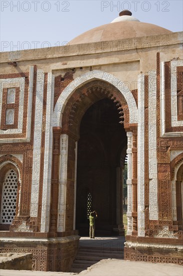 Man Taking Picture in Archway of Tall Mosque, New Delhi, India