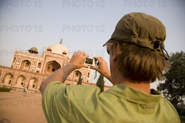 Man Taking Photo of Humayun's Tomb, New Delhi, India