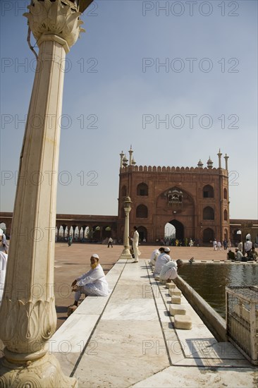 Men Sitting by Jama Masjid Mosque Pool, Delhi, India