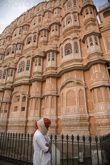 Indian Man Walking by Ornate Building in Pink City