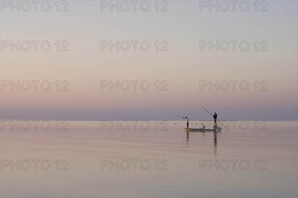 Two Men Fishing in Boat on Calm Water, Florida Keys, USA