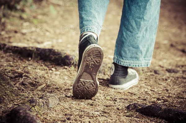 Woman Walking Along Hiking Trail, Rear View of Feet