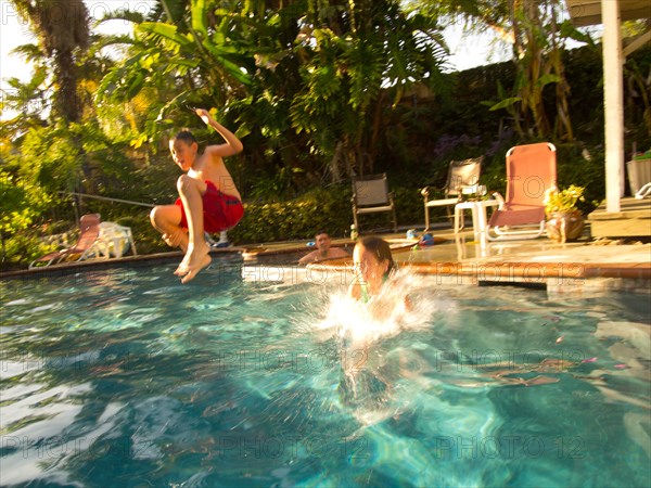 Boy Jumping in Pool