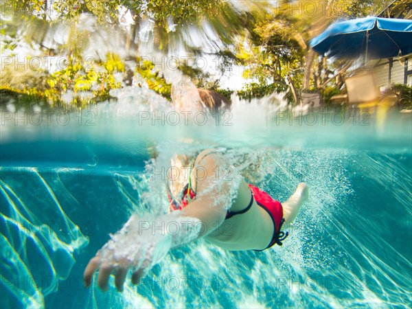 Girl Swimming in Pool, Underwater View