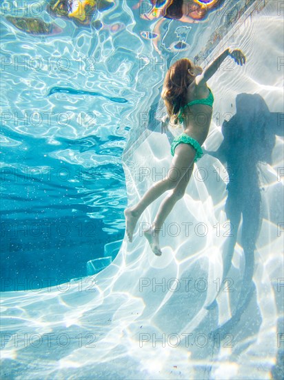 Girl Swimming Underwater, Going Up For Air