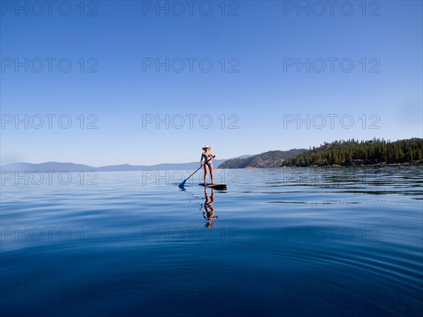 Woman Paddling on Lake